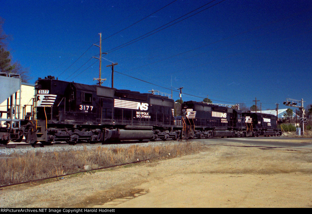 NS 3322 leads NS 3173 & 3177 across Fairview Road towards the yard